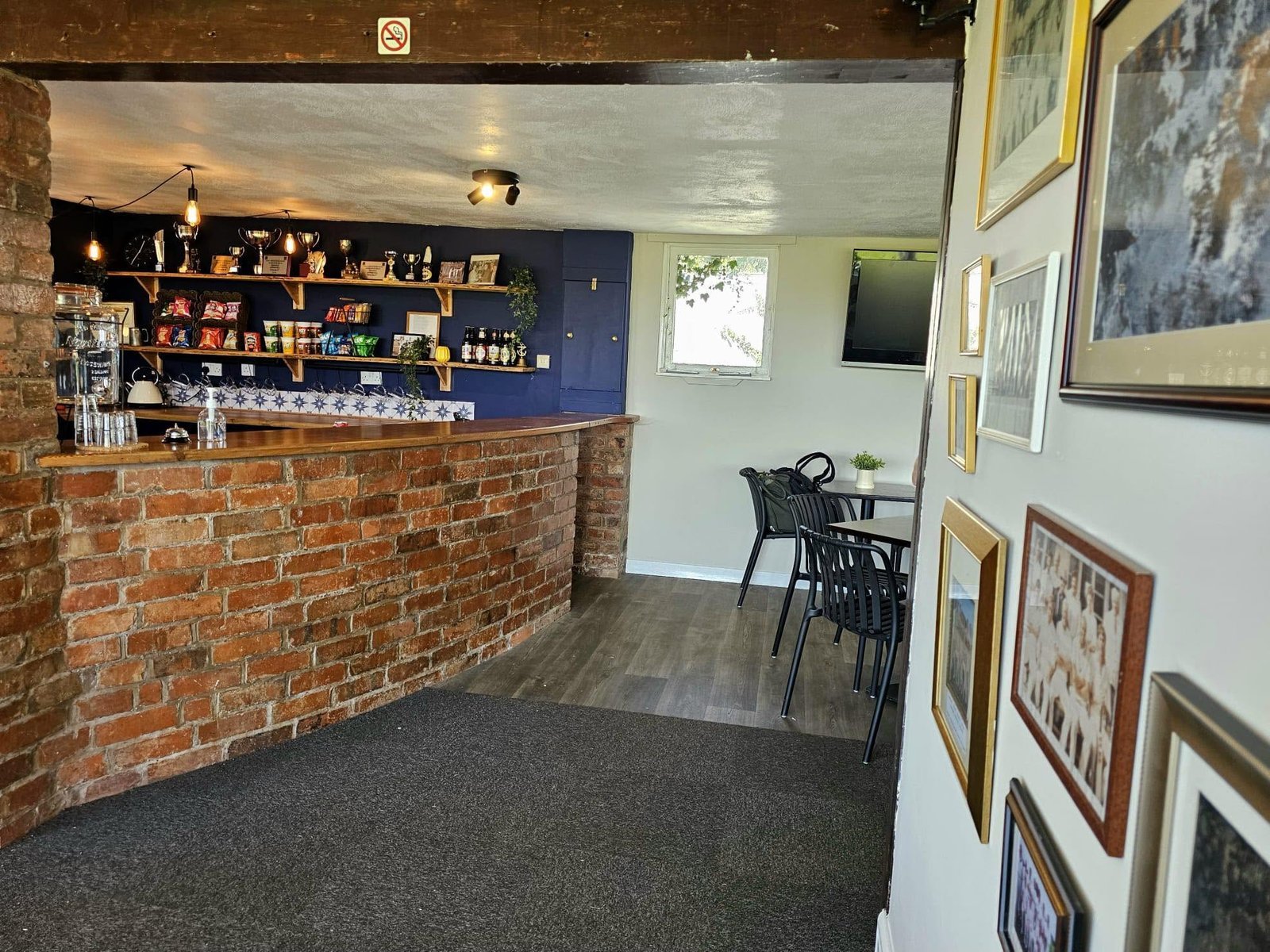 Audlem CC refurbished bar from the lounge — brick counter and trophy shelves