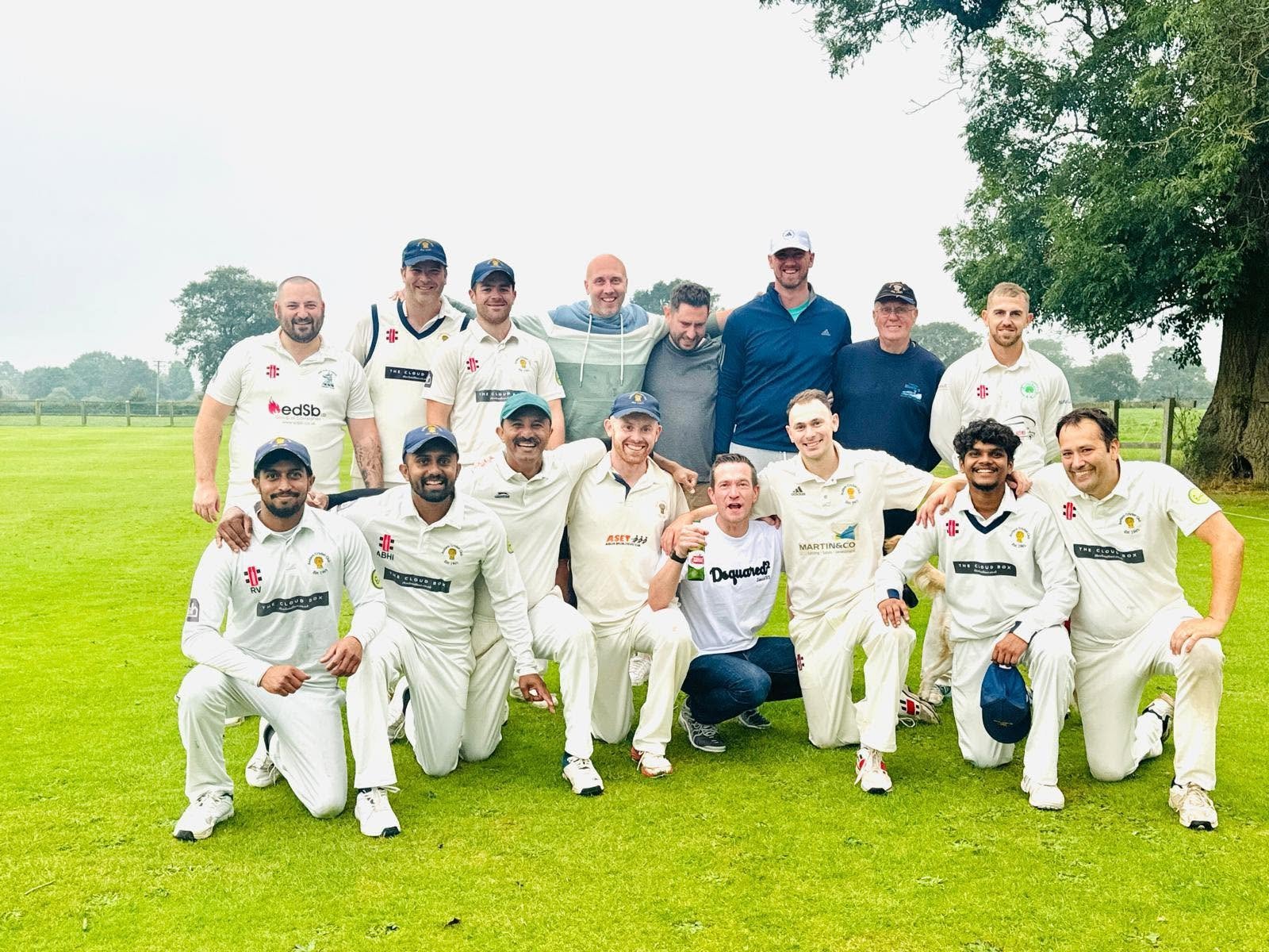 Audlem Cricket Club team celebrating on the outfield at The Gorse Croft