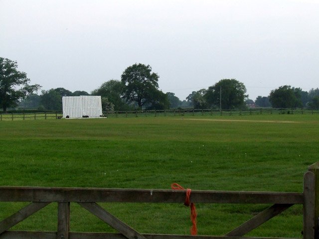 View across Audlem Cricket Club ground with sight screen and square